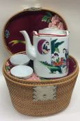 A cased tapering wicker tea service of Chinese des