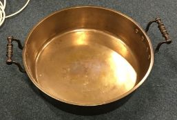 A heavy brass mounted two handled preserve pan. Es