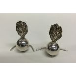 A pair of unusual silver menu holders in the form