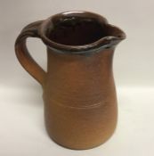 MUCHELNEY: A John Leach tapering stoneware jug wit