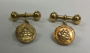 A pair of unusual 18 carat gold cufflinks depictin