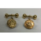 A pair of unusual 18 carat gold cufflinks depictin