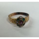 A Victorian amethyst and emerald cluster ring in 1