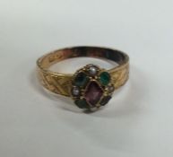 A Victorian amethyst and emerald cluster ring in 1