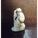 A small carved ivory netsuke of an Oriental man. E
