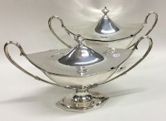 A good pair of Georgian faceted silver tureens and
