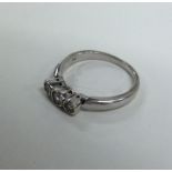 A white gold and diamond three stone ring in rubov