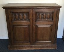 A large two door oak cupboard on pedestal base. Es