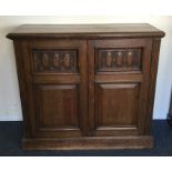 A large two door oak cupboard on pedestal base. Es