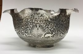 A large Indian silver bowl attractively decorated