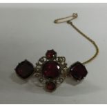 A garnet and pearl Antique brooch set with safety