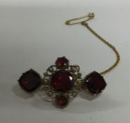 A garnet and pearl Antique brooch set with safety