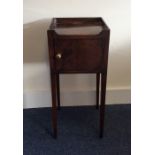 A Georgian mahogany bedside cabinet on tapering le