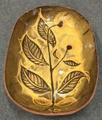 A large oval earthenware pottery dish decorated wi