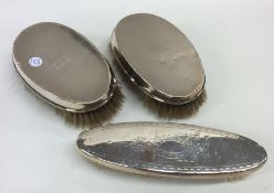 A pair of silver mounted hair brushes of engine tu