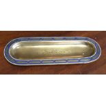 A Continental brass oval pen tray with enamelled d