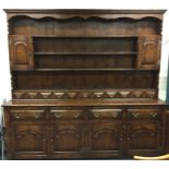 A massive oak four drawer and four door dresser wi