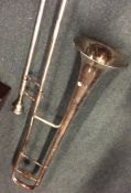 A large silver plated trombone. Est. £50 - £80.