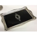 A large silver and tortoiseshell inlaid tray decor