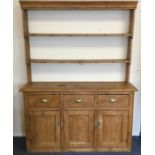 A good stripped pine three drawer kitchen dresser