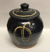 A dark brown glazed earthenware