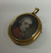 An oval gold miniature with loop top and locket ba