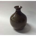 A small baluster shaped earthenware vase with text