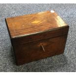 A walnut tea caddy with fitted interior. Est. £20
