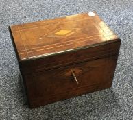 A walnut tea caddy with fitted interior. Est. £20