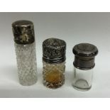 A group of three silver mounted scent bottles. Est
