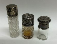 A group of three silver mounted scent bottles. Est