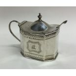 A large bright cut silver engraved mustard pot. Lo