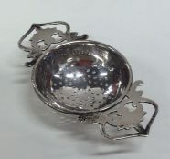 An Edwardian silver tea strainer. Birmingham. Appr