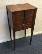 A Dutch marquetry two door side table on tapering