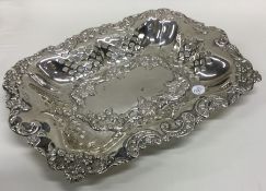A heavy Edwardian silver basket decorated with flo