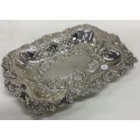 A heavy Edwardian silver basket decorated with flo