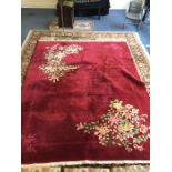 A large patterned carpet in bright colours. Est. £