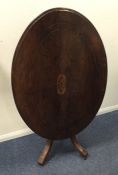 A late Victorian oval top table with scroll inlay.