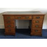 An Edwardian mahogany nine drawer desk. Est. £80 -