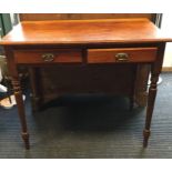 An Edwardian two drawer writing desk. Est. £20 - £