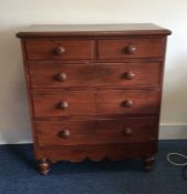 A mahogany chest of five drawers on turned support