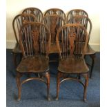 A set of eight oak Windsor chairs with stick backs