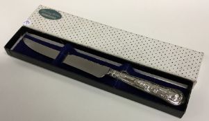 A cased Queens' pattern silver cake knife. Approx.