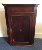 A Georgian mahogany corner cupboard with shell inl