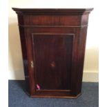 A Georgian mahogany corner cupboard with shell inl