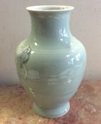 A large baluster shaped celadon vase of plain desi