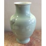 A large baluster shaped celadon vase of plain desi