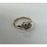 A Victorian three stone diamond crossover ring in