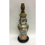 A Chinese Canton vase decorated in bright colours.
