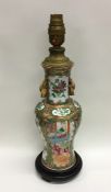 A Chinese Canton vase decorated in bright colours.